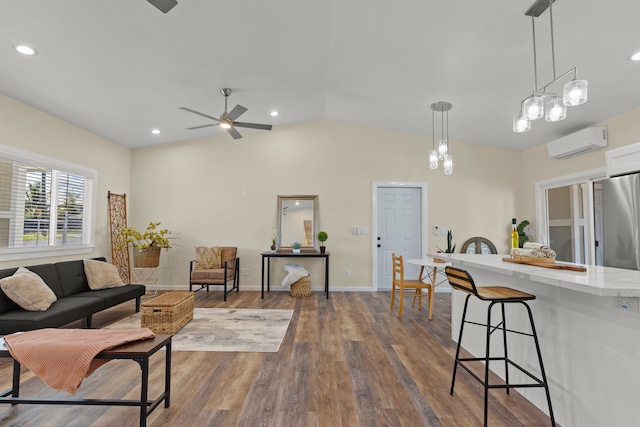 living room with lofted ceiling, a wall mounted AC, dark wood-type flooring, and ceiling fan