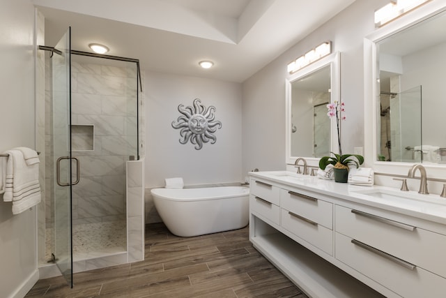 bathroom featuring vanity, hardwood / wood-style flooring, and separate shower and tub