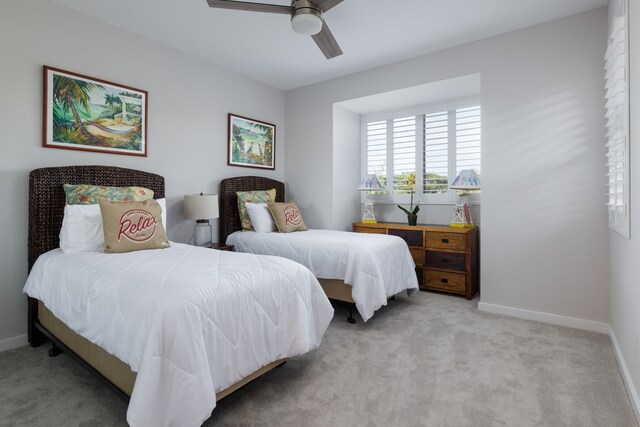 bedroom with ceiling fan and light carpet