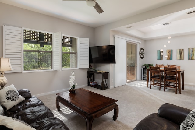 living room with light colored carpet and ceiling fan