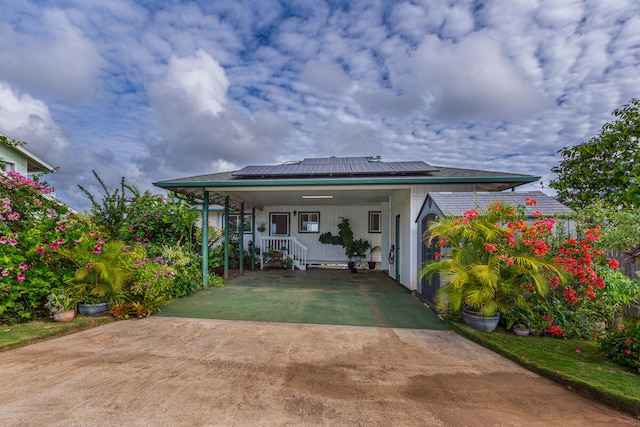 back of property featuring solar panels and a porch