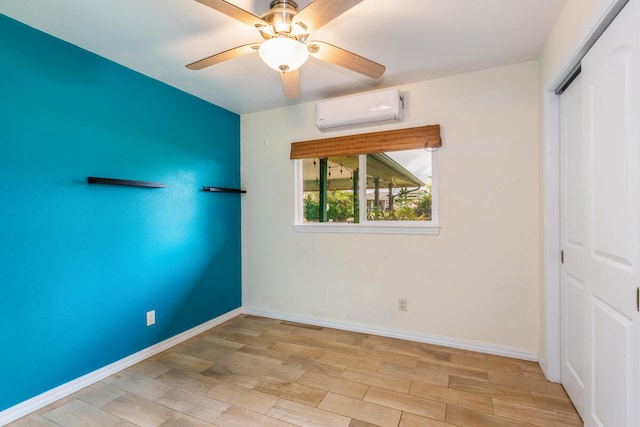 unfurnished bedroom with a closet, an AC wall unit, ceiling fan, and light hardwood / wood-style floors