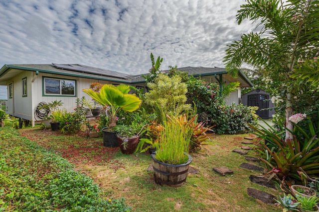 view of home's exterior featuring a shed and solar panels