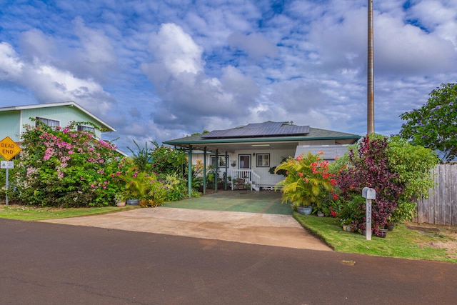 view of front of house with covered porch and solar panels