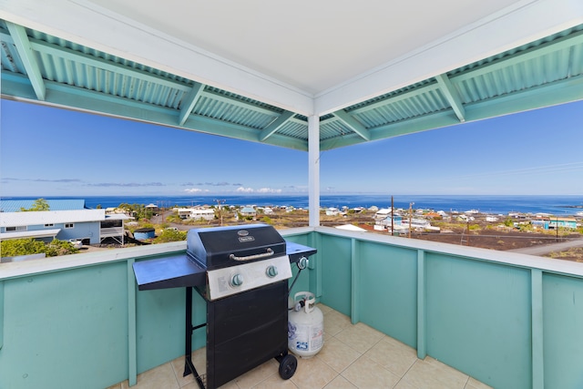 view of patio with a water view and area for grilling