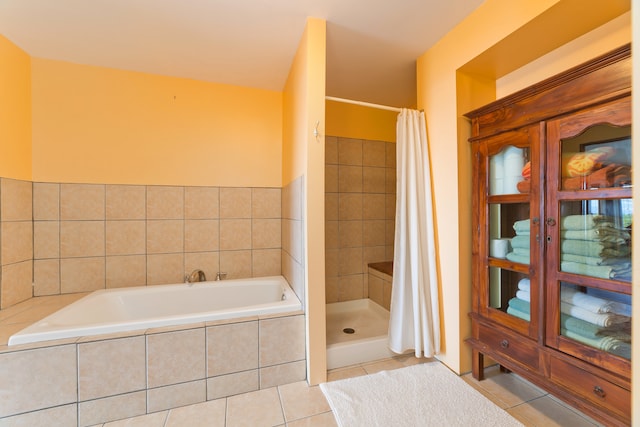 bathroom featuring tile patterned floors and independent shower and bath