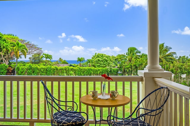 wooden deck featuring a lawn