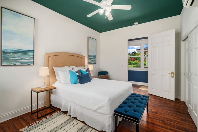 bedroom featuring a closet, a wall mounted air conditioner, dark hardwood / wood-style floors, and ceiling fan