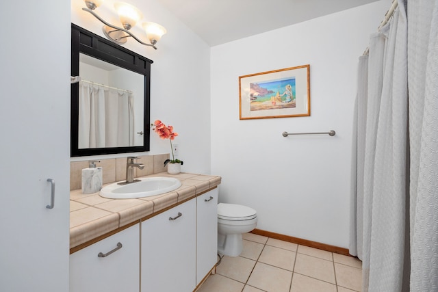 bathroom with tile patterned flooring, vanity, and toilet