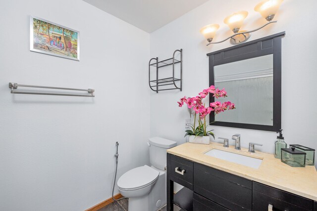 bathroom featuring tile patterned floors, vanity, and toilet