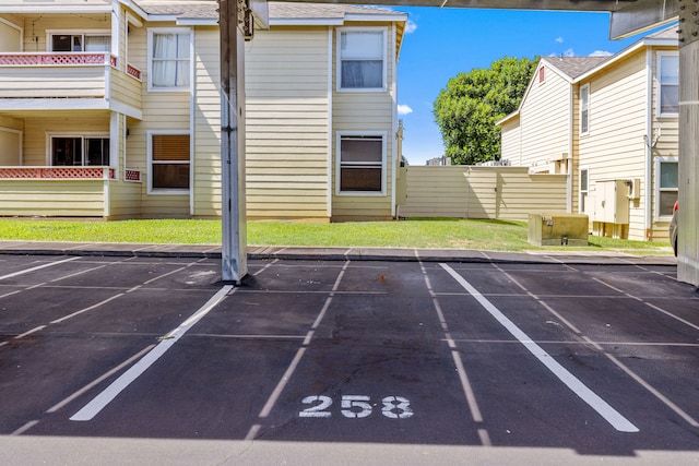 view of parking featuring a lawn