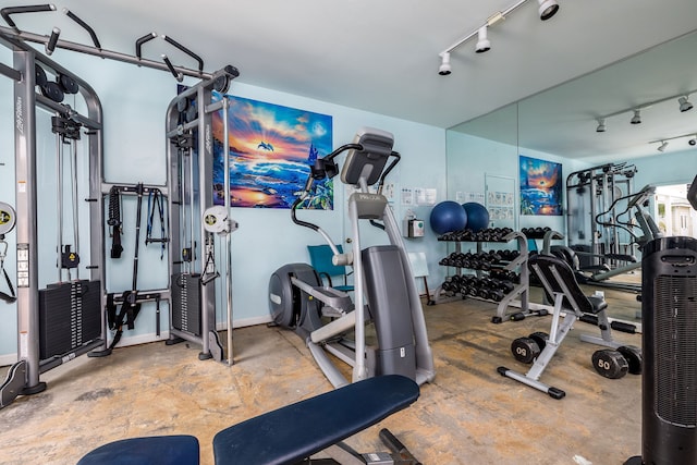 exercise room with concrete floors and track lighting