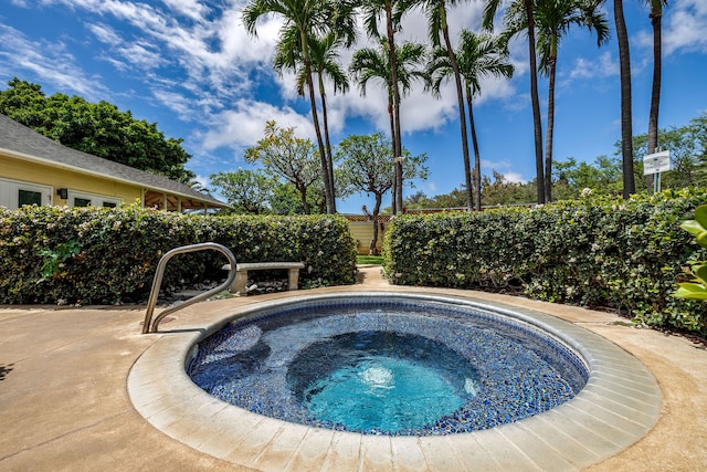 view of pool with an in ground hot tub