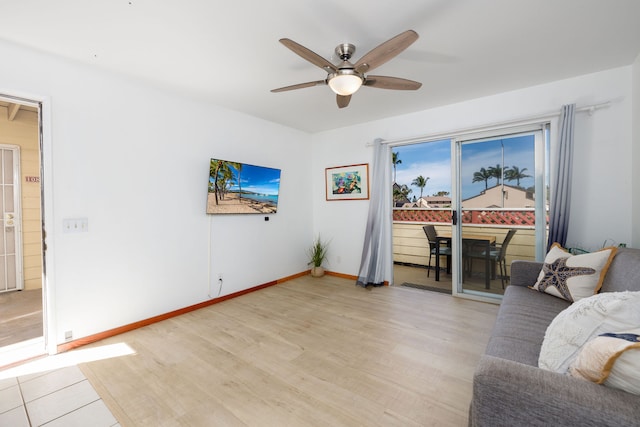 living room with ceiling fan and light hardwood / wood-style floors