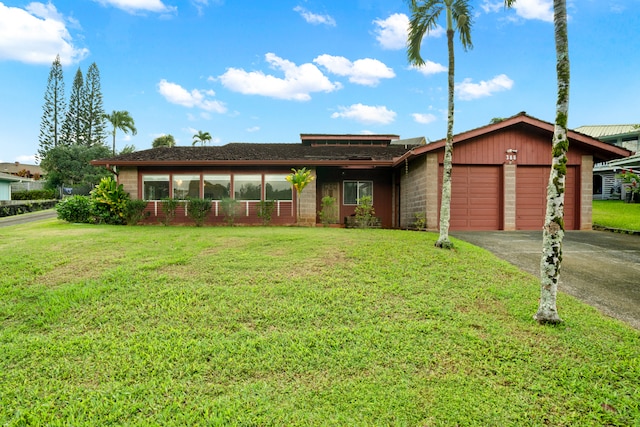 ranch-style house with a front yard and a garage