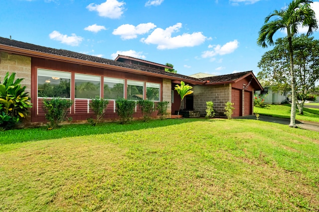 view of front of house with a front yard and a garage