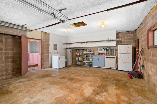 garage featuring washer / dryer, electric water heater, and white fridge