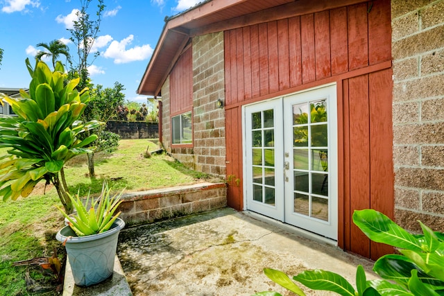 view of side of home featuring french doors and a patio area