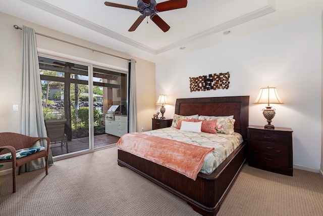 carpeted bedroom featuring ornamental molding, access to exterior, a raised ceiling, and ceiling fan