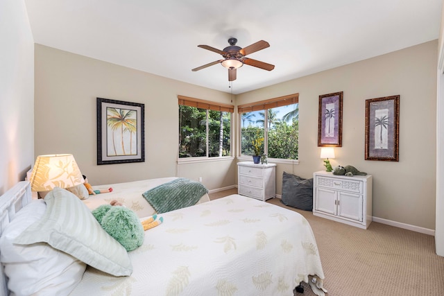 bedroom with ceiling fan and light colored carpet