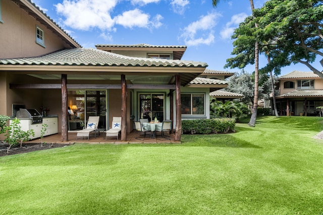 rear view of property featuring a patio and a yard