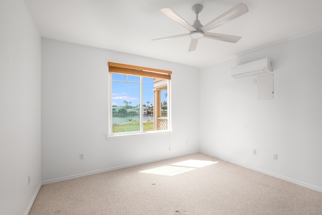 unfurnished room featuring light colored carpet, an AC wall unit, a water view, and ceiling fan