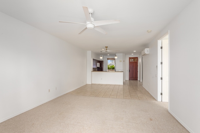 unfurnished living room featuring an AC wall unit, light colored carpet, and ceiling fan