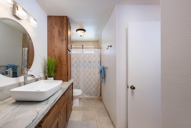 bathroom with vanity, curtained shower, and toilet