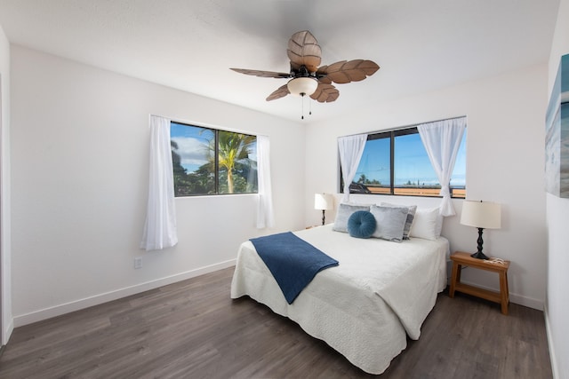 bedroom with dark hardwood / wood-style floors and ceiling fan