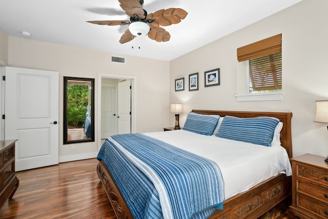 bedroom with baseboards, visible vents, wood finished floors, and ceiling fan