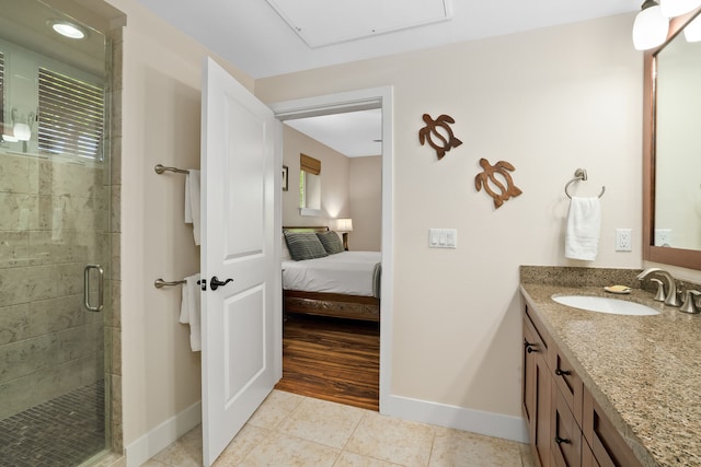 full bath with baseboards, tile patterned floors, a stall shower, and vanity