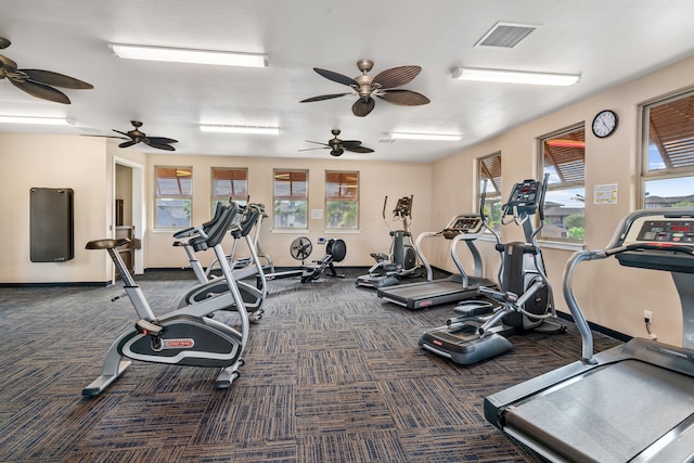 gym featuring a ceiling fan, visible vents, carpet floors, and baseboards
