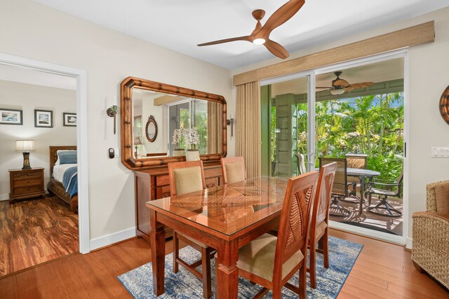 dining area featuring baseboards, wood finished floors, and ceiling fan