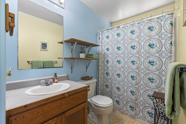 bathroom with toilet, vanity, and tile patterned flooring