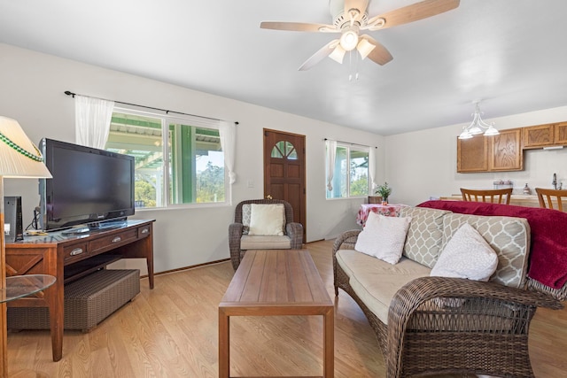 living room featuring light hardwood / wood-style floors and ceiling fan