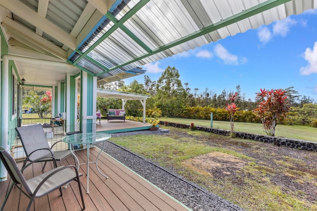 wooden deck featuring a lawn