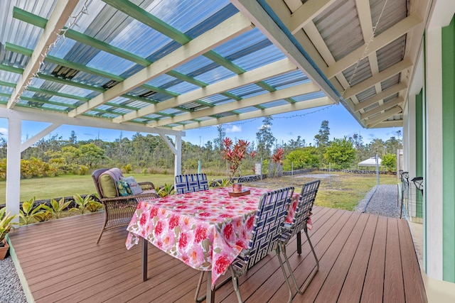 wooden terrace featuring a yard and a pergola