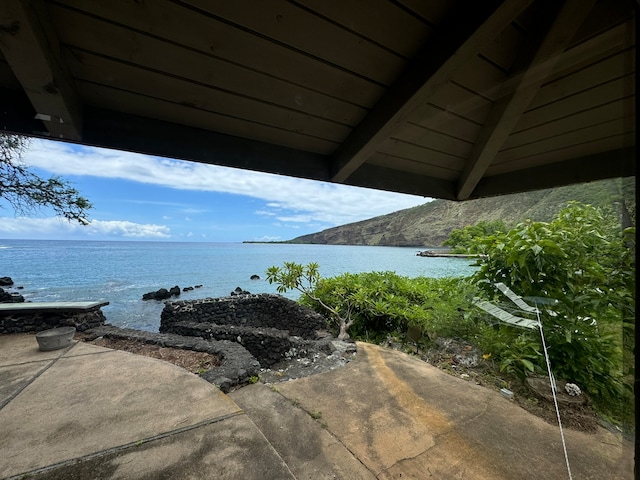 view of patio featuring a water and mountain view