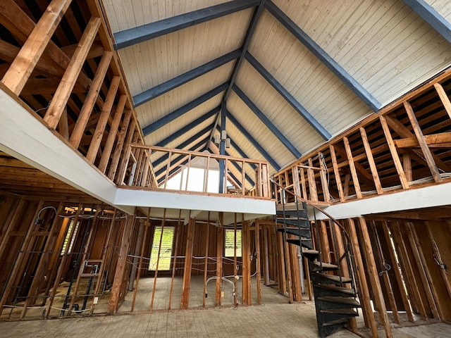 miscellaneous room featuring beam ceiling and high vaulted ceiling