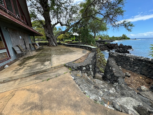 view of yard with a patio area and a water view