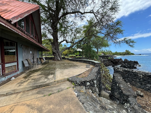 view of yard featuring a patio and a water view