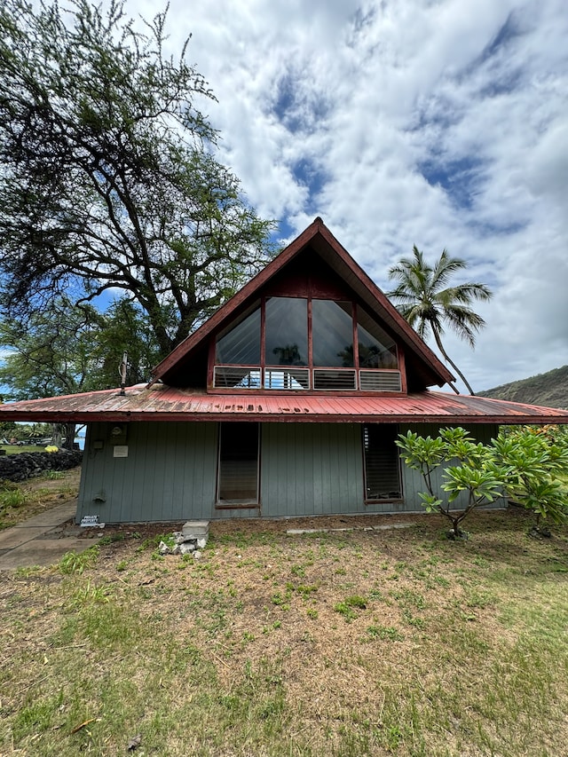 back of property featuring a yard