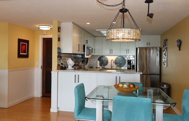 dining room featuring light hardwood / wood-style floors and sink