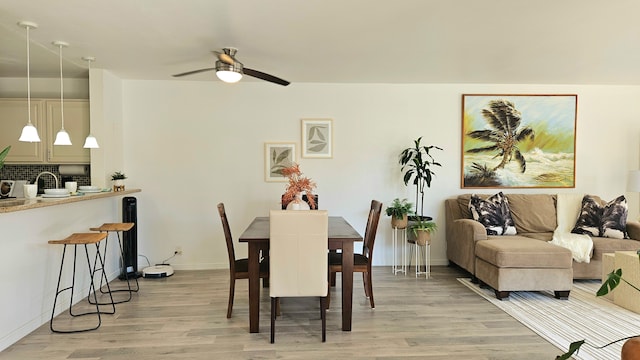 dining room featuring light wood-type flooring and ceiling fan