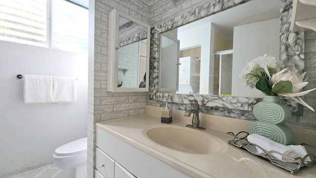 bathroom featuring walk in shower, vanity, tile patterned floors, and toilet