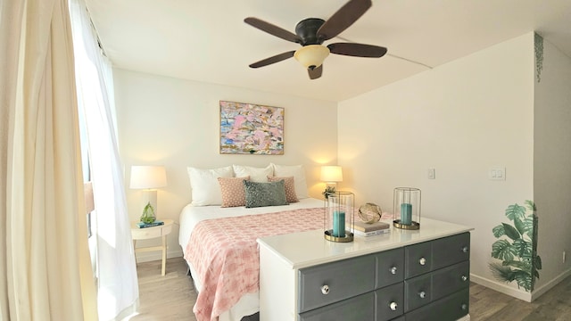 bedroom featuring ceiling fan and dark hardwood / wood-style floors