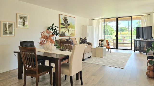 dining area featuring expansive windows and light wood-type flooring