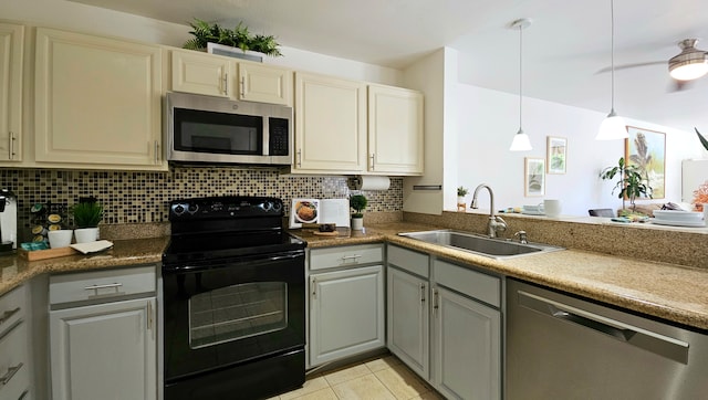 kitchen featuring gray cabinets, appliances with stainless steel finishes, hanging light fixtures, and sink