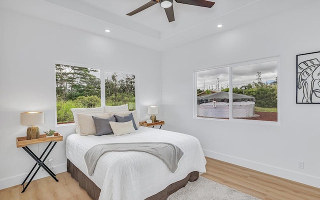 bedroom featuring light wood-type flooring and ceiling fan