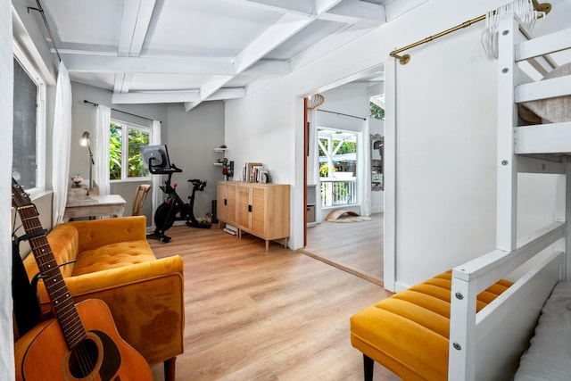 sitting room featuring light wood-type flooring and beam ceiling